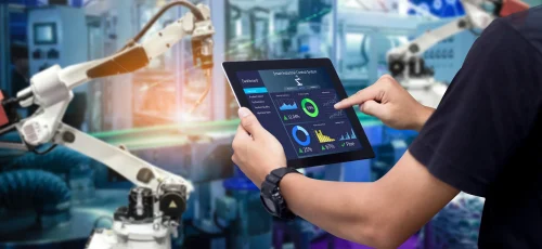 16x9 hands holding tablet blurred automation machine background SHS 1457193278.2400